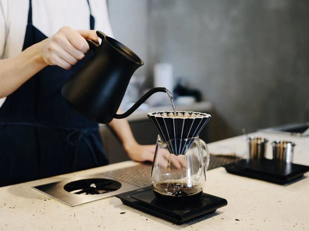 Pink Comandante Origami Dripper M coffee grinder with a sleek, compact design for fresh brewing.