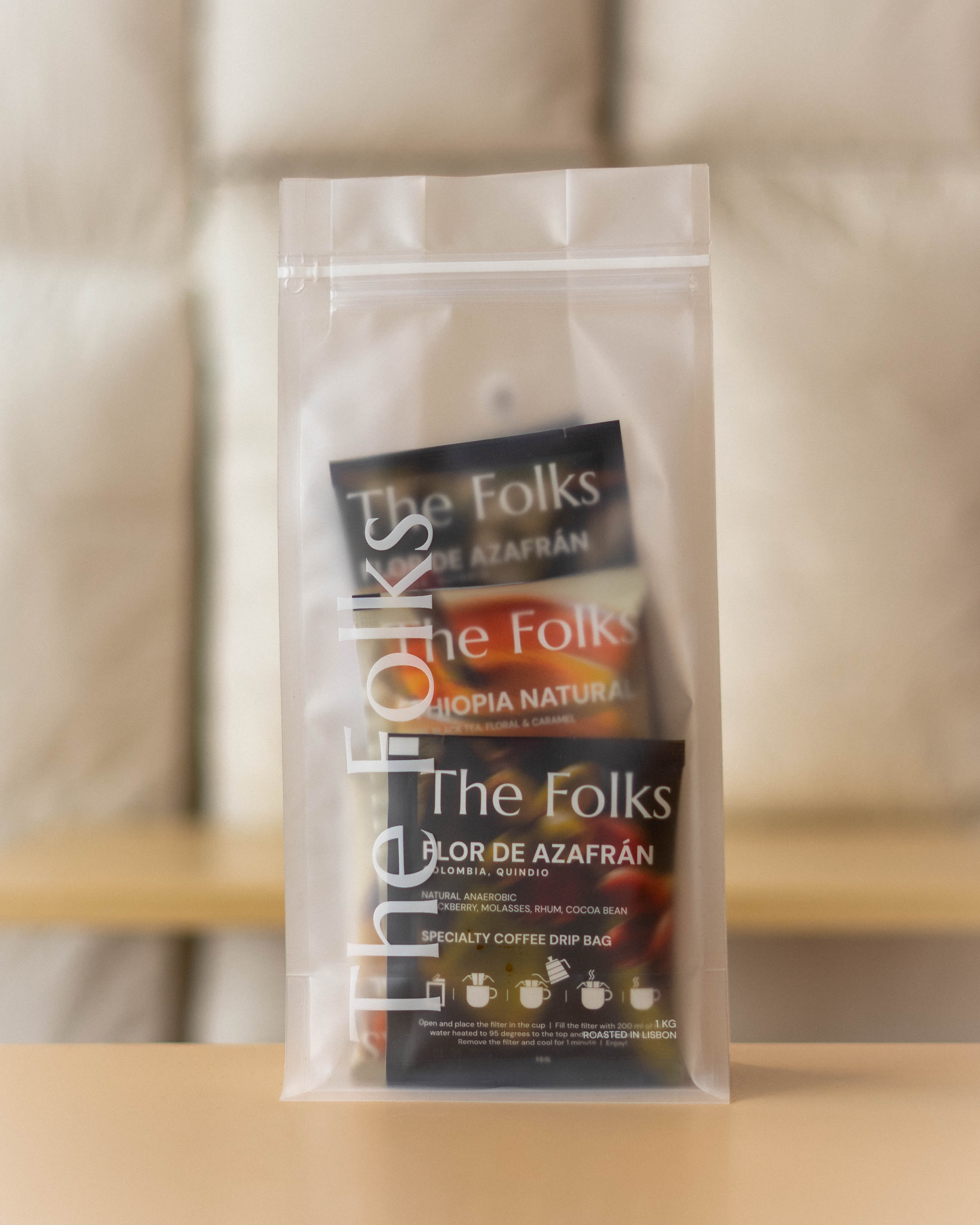 The Folks Colombia drip coffee beans with Flor de Azafrán label, showcasing a single pack of coffee beans in natural light.