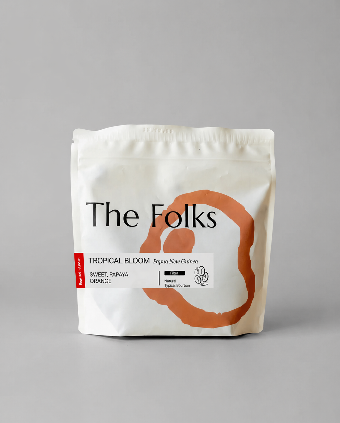 Fresh Tropical Bloom coffee beans from Papua New Guinea by The Folks, showcasing a vibrant bag of high-quality coffee beans.