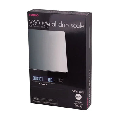 Comandante black coffee grinder with Hario V60 metal drip scale for precise brewing and measurement.