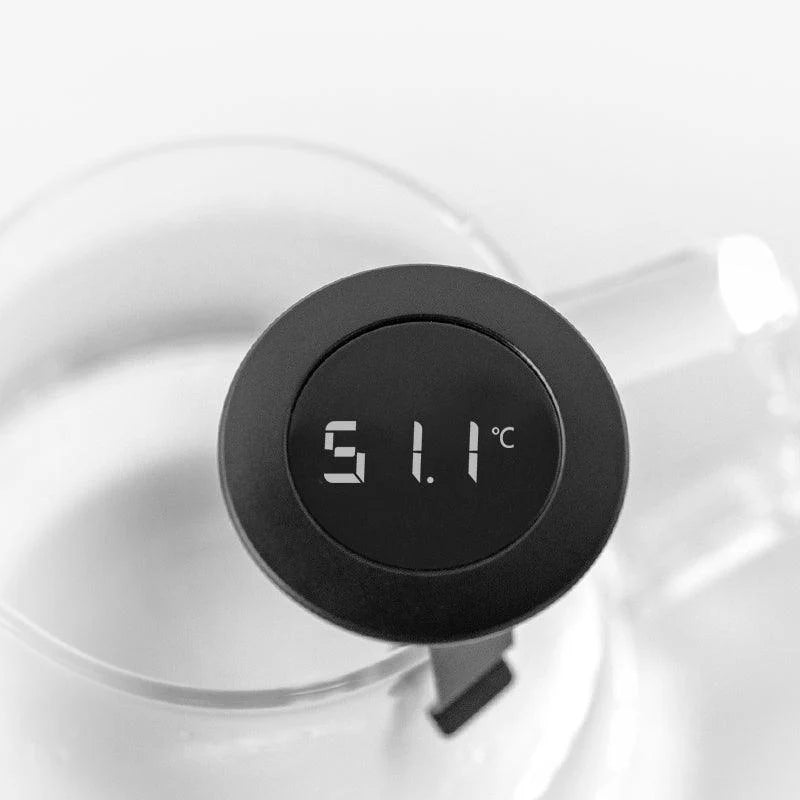 Comandante coffee grinder with Timemore digital thermometer attached, showing a close-up of the grinder's handle and temperature display.