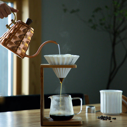 Orange Comandante coffee grinder with Origami Dripper S for fresh brewing, featuring a compact and stylish design.