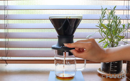 HARIO Mugen Switch black coffee grinder by MIIR, with ceramic burrs and adjustable grind settings on a sleek black device.