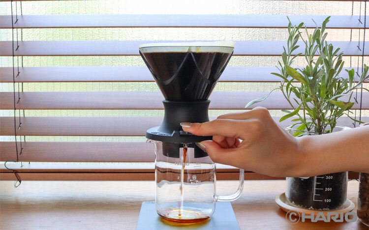 HARIO Mugen Switch black coffee grinder by MIIR, with ceramic burrs and adjustable grind settings on a sleek black device.