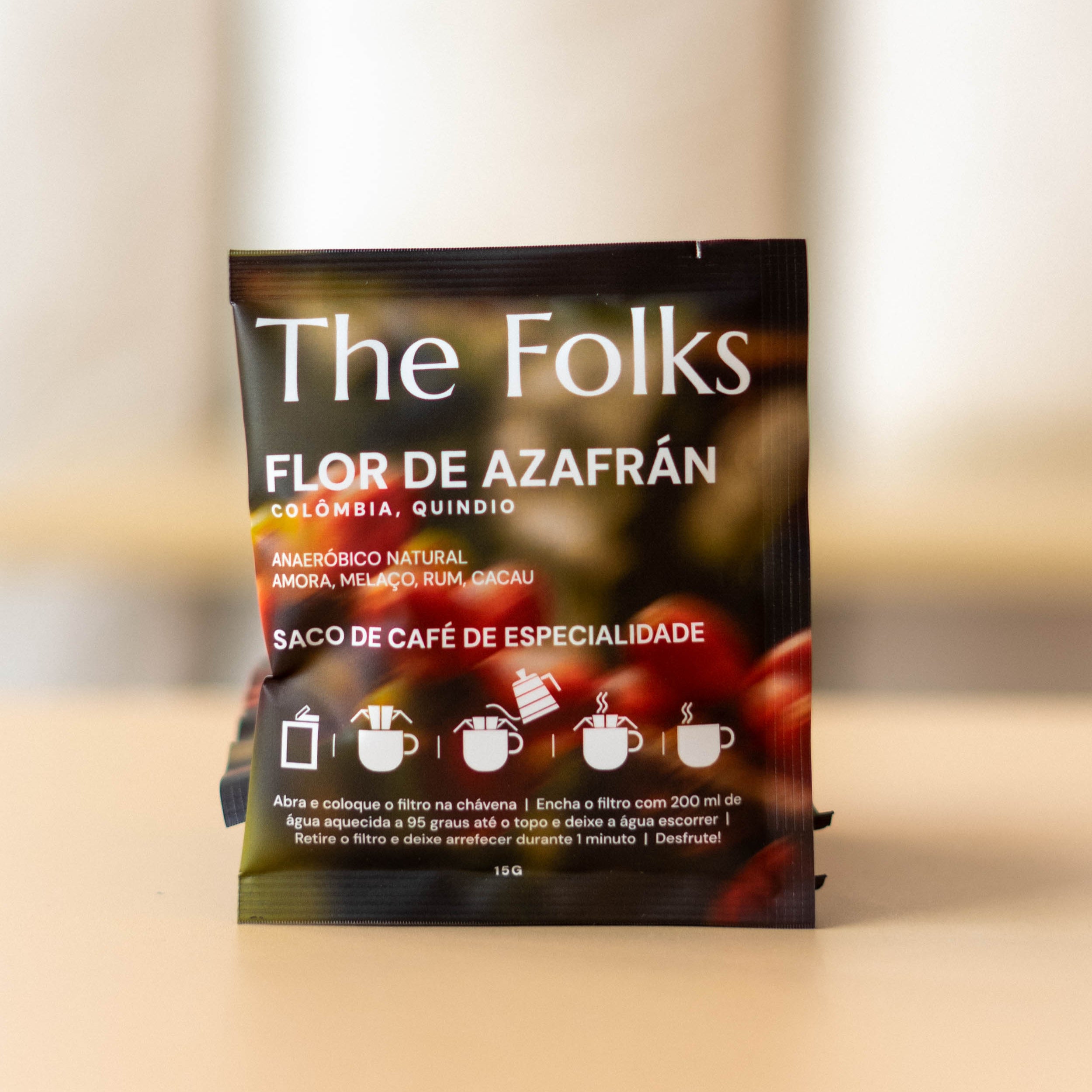 The Folks Colombia drip coffee beans in a pack with floral Azafrán branding, showcasing fresh roasted coffee beans.