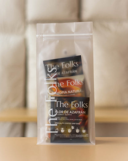 The Folks Colombia drip coffee beans with Flor de Azafrán label, showcasing a single pack of coffee beans in natural light.