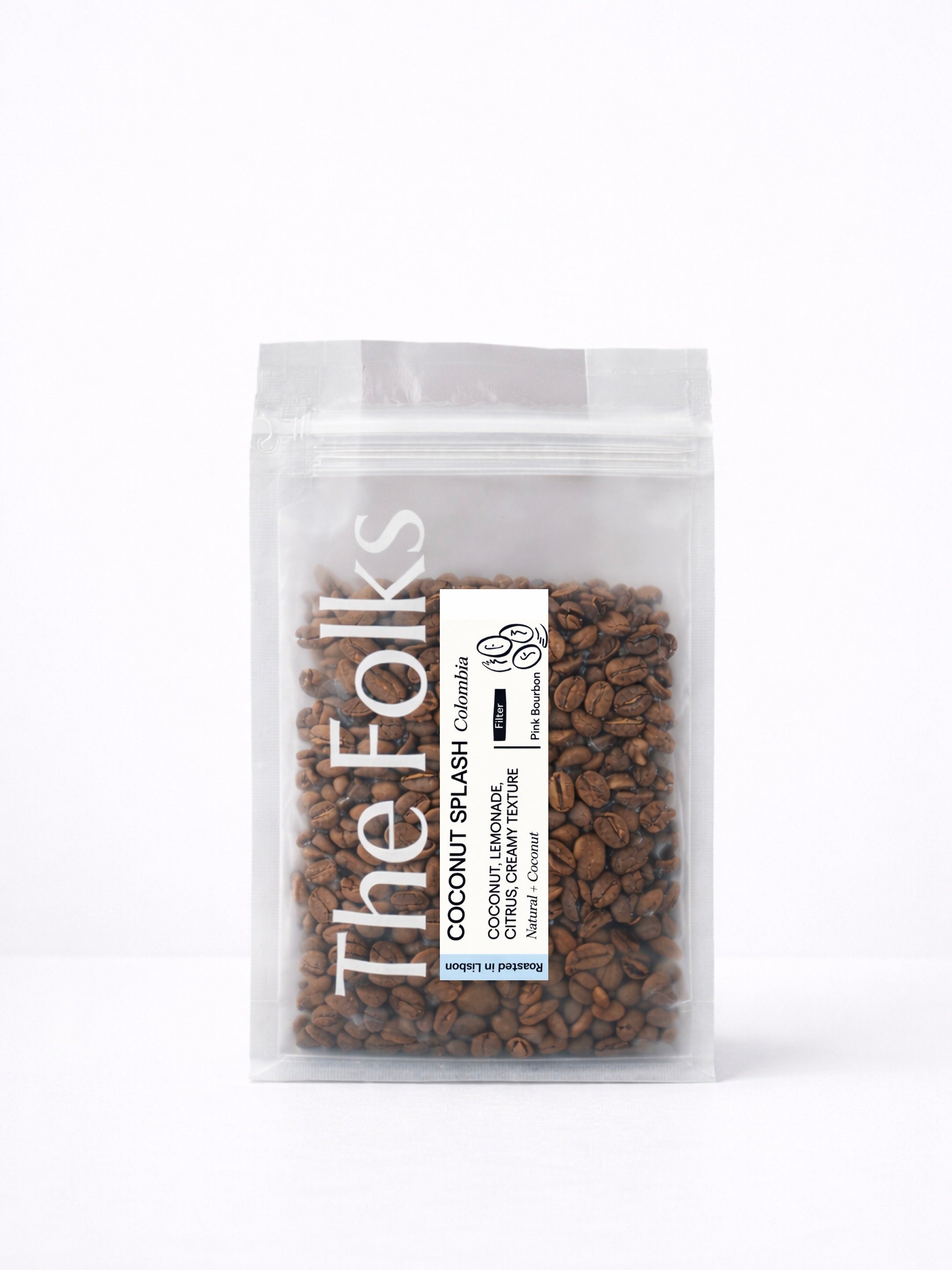 Bag of The Folks Coconut Splash Colombia beans showing fresh, light brown coffee beans in a clear bag.