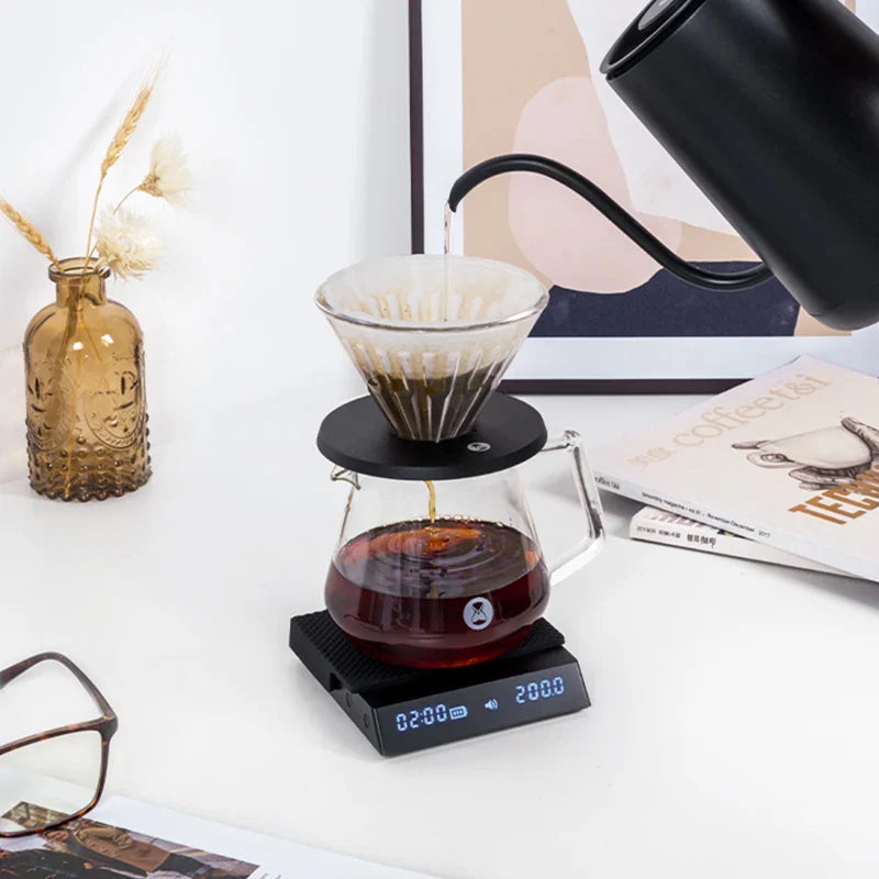 Timemore Black Mirror Nano coffee scale with built-in timer and sleek black design, used for precise coffee brewing measurements.