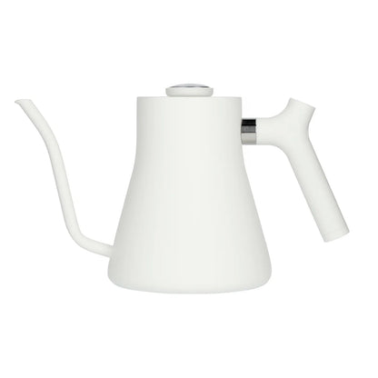 Fellow Stagg white kettle with a sleek design, featuring a gooseneck spout and digital temperature control for precise brewing.